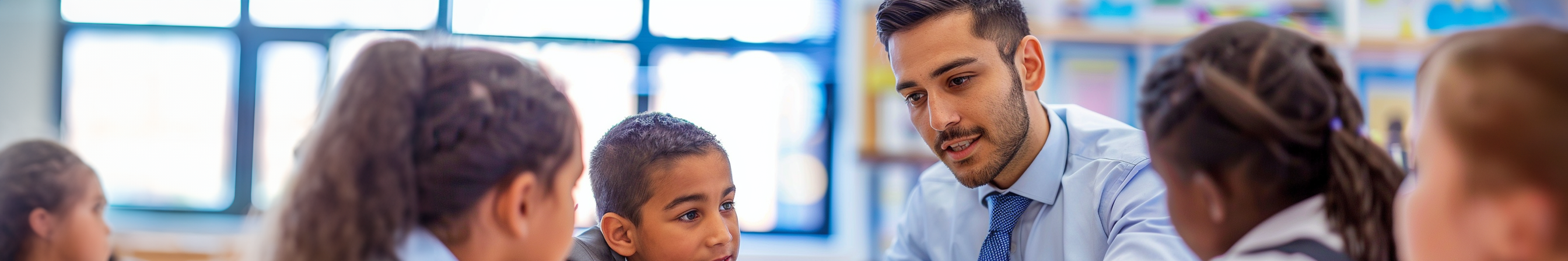 Teacher working with a group of pupils.